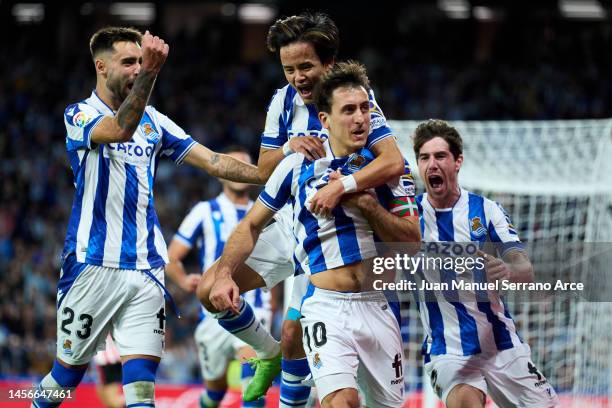 Mikel Oyarzabal of Real Sociedad celebrates with his teammates Brais Mendez, Aritz Elustondo and Takefusa Kubo of Real Sociedad after scoring his...