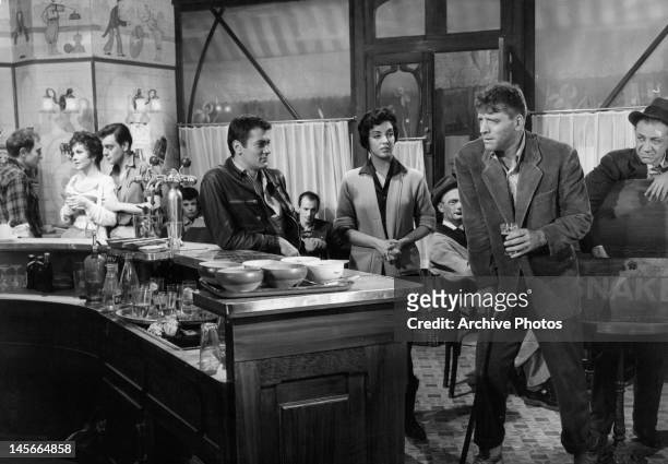 Gina Lollobrigida, Tony Curtis, Katy Jurado, and Burt Lancaster at a French bistro in a scene from the film 'Trapeze', 1956.