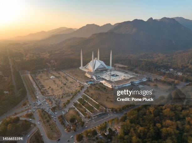 aerial photo of islamabad, the capital city of pakistan showing the landmark shah faisal mosque and the lush green mountains of the city - pakistan monument fotografías e imágenes de stock