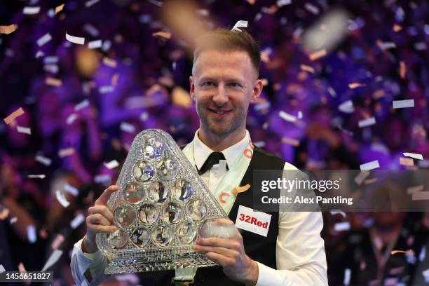 Judd Trump of England celebrates with the Paul Hunter trophy following his victory in the Cazoo Masters Final against Mark Williams of Wales at...