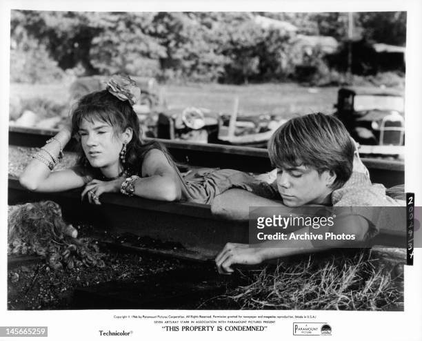 Mary Badham and boy hanging on the railroad tracks in a scene from the film 'This Property Is Condemned', 1966.