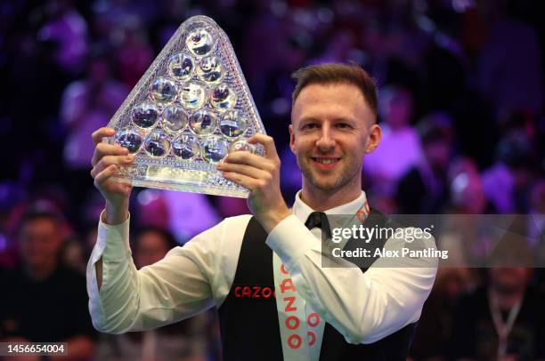 Judd Trump of England celebrates with the Paul Hunter trophy following his victory in the Cazoo Masters Final against Mark Williams of Wales at...