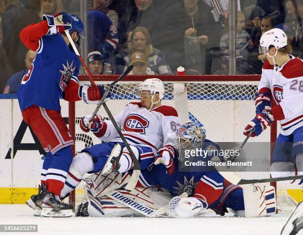 Ben Harpur of the New York Rangers pushes Evgenii Dadonov of the Montreal Canadiens into Igor Shesterkin during the second period at Madison Square...