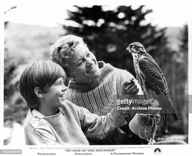 Woman holding bird for Ted Eccles in a scene from the film 'My Side Of The Mountain', 1969.