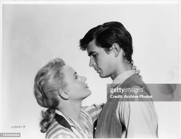 Elaine Aiken and Anthony Perkins embracing in a scene from the film 'The Lonely Man', 1957.