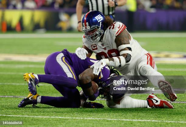 Dalvin Cook of the Minnesota Vikings is tackled by Leonard Williams of the New York Giants during the fourth quarter in the NFC Wild Card playoff...