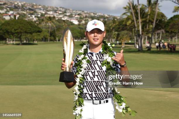 Si Woo Kim of South Korea poses with the trophy after putting in to win on the 18th green during the final round of the Sony Open in Hawaii at...