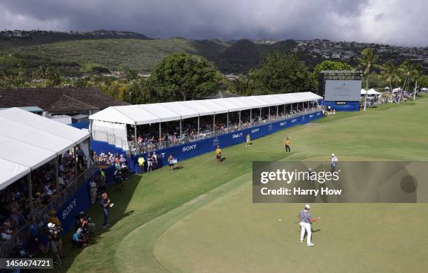 Si Woo Kim of South Korea reacts to his birdie putt on the 18th green during the final round of the Sony Open in Hawaii at Waialae Country Club on...