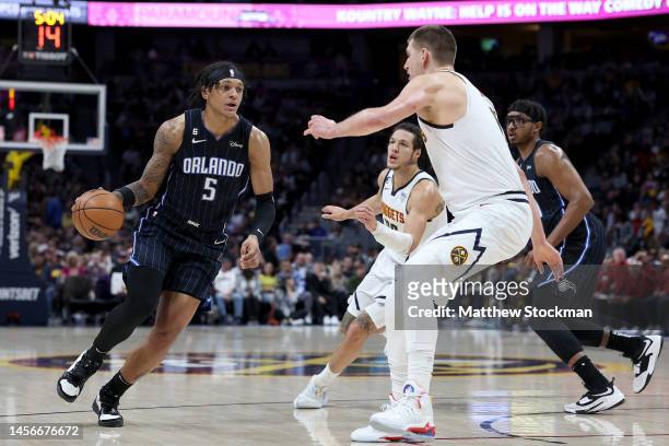 Paolo Banchero of the Orlando Magic drives against Nikola Jokic of the Denver Nuggets in the first quarter at Ball Arena on January 15, 2023 in...
