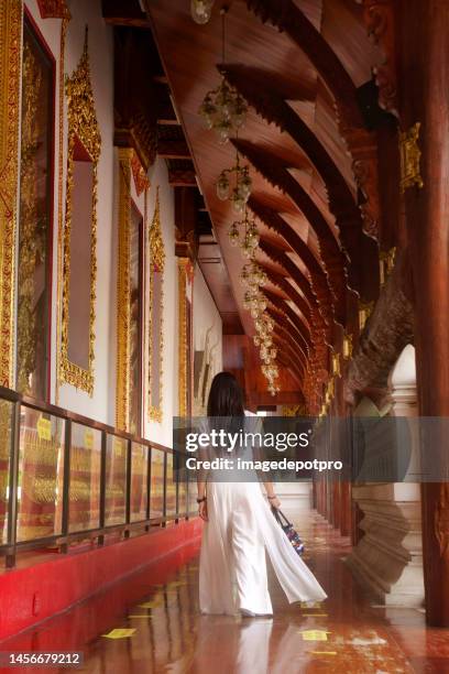 young asian woman in ancient buddhist temple - thai people stock pictures, royalty-free photos & images
