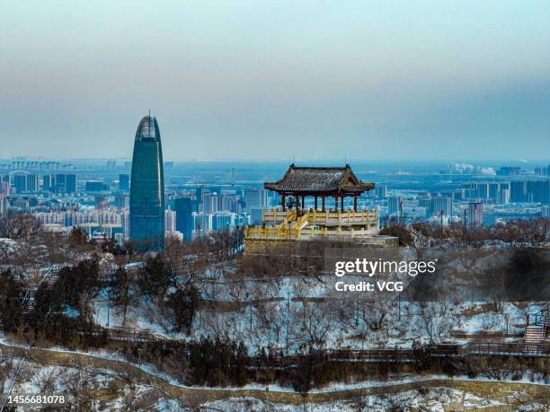 Aerial view of snow-covered ancient buildings at Qianfo Mountain Scenic Spot on January 15, 2023 in Jinan, Shandong Province of China.