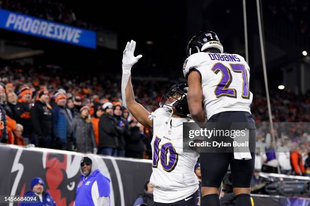 Demarcus Robinson of the Baltimore Ravens celebrates with J.K. Dobbins after scoring a 41 yard touchdown pass against the Cincinnati Bengals during...