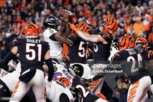 Tyler Huntley of the Baltimore Ravens fumbles the ball that is recovered by Sam Hubbard of the Cincinnati Bengals to score a 98 yard touchdown during...