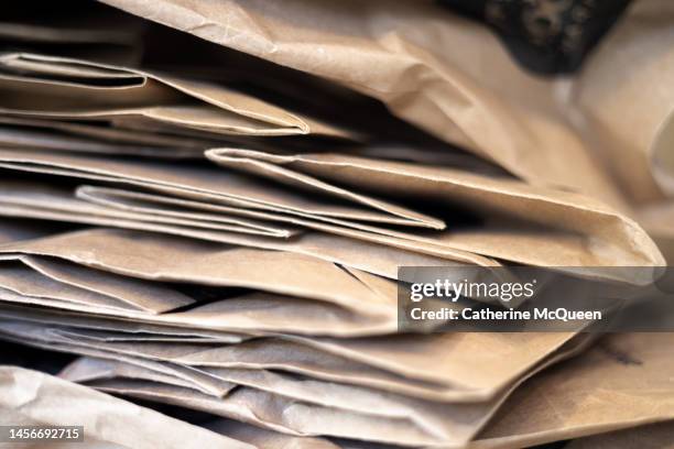 full frame of stack of used paper bags - paper industry stock pictures, royalty-free photos & images