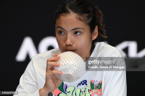 Emma Raducanu of Great Britain drinks a coconut water as she speaks to media after her round one singles match win against Tamara Korpatsch of...