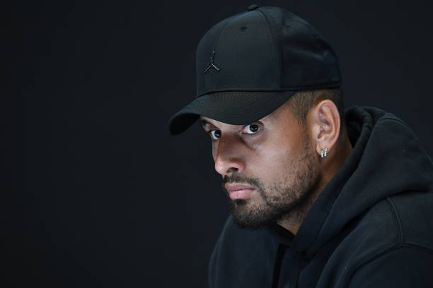 Nick Kyrgios of Australia speaks to media to announce his withdrawal from the tournament due to a knee injury during day one of the 2023 Australian...