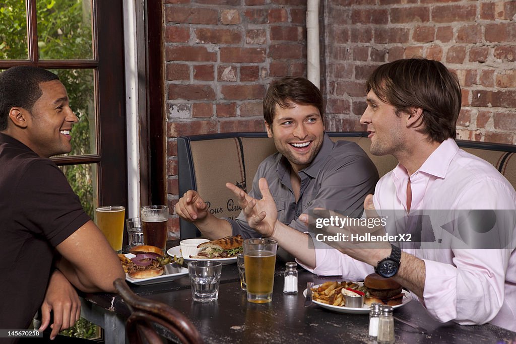 Guys hanging out over beers at dinner