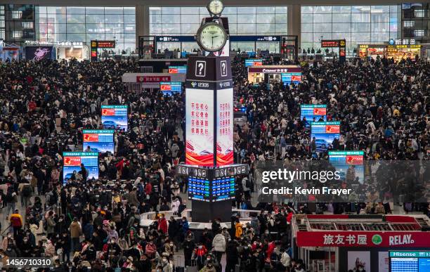 Travellers crowd at the gates and wait for trains at the Shanghai Hongqiao Railway Station during the peak travel rush for the upcoming Chinese New...