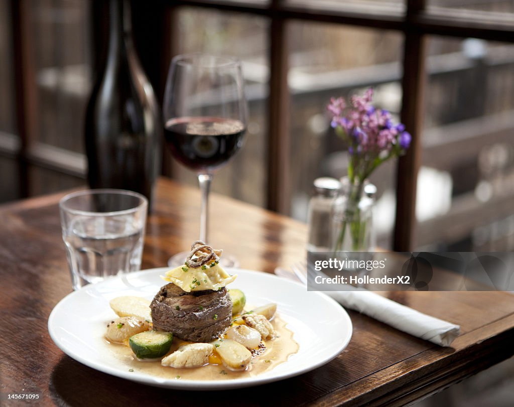 Meal with glass of wine on table