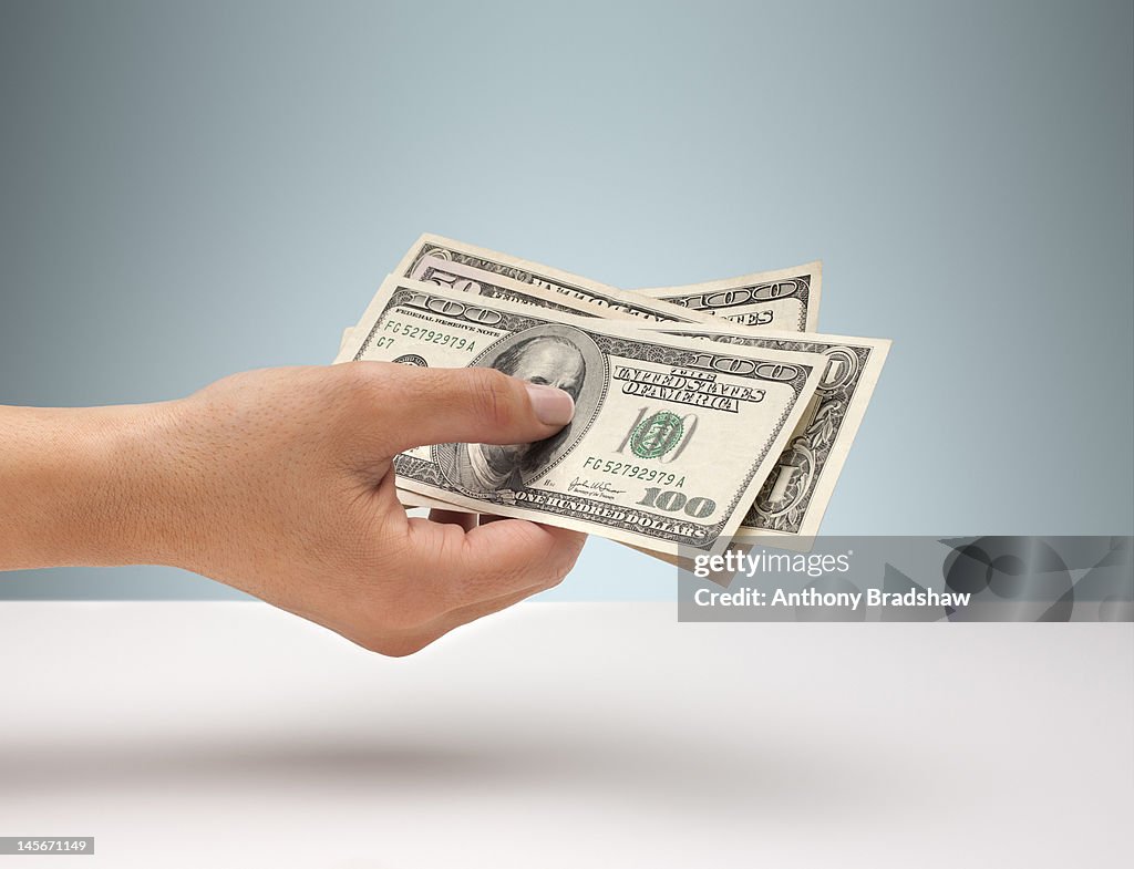 Hand holding American currency