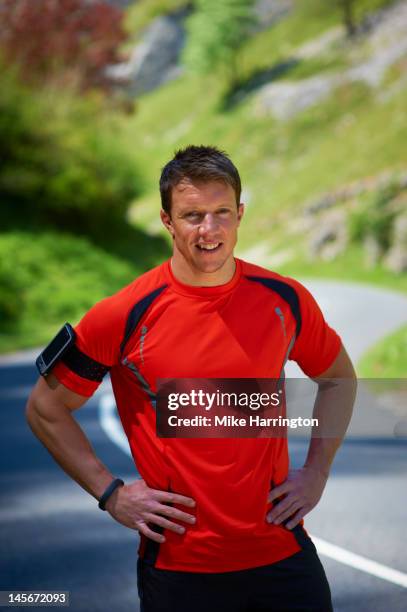 portrait of male runner in mountains - arms akimbo stock pictures, royalty-free photos & images