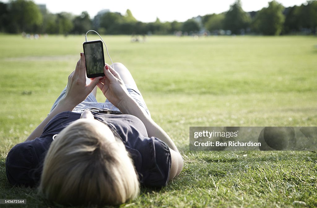 Young woman with smart phone outside