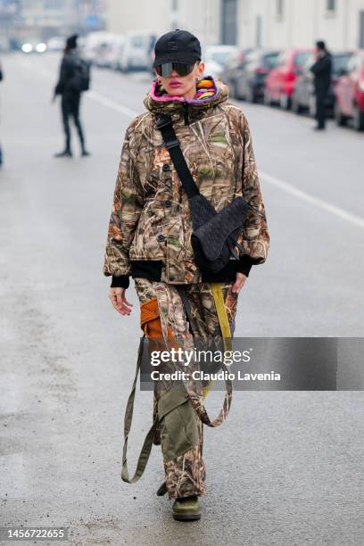 Katya Tolstova is seen wearing camouflage parka and cargo pants, Fendi cap and Dior bag outside the Etro show during the Milan Menswear Fall/Winter...