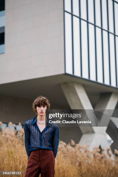 Daniel Millar is seen wearing blue button shirt and brown flared pants outside the Etro show during the Milan Menswear Fall/Winter 2023/2024 on...