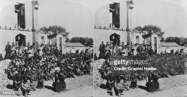 Stereoscopic image showing Miss Smith sitting with the refugees she protected during the Siege of Beijing, during the Boxer Rebellion, among the...