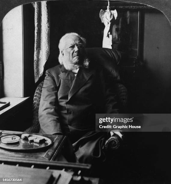 Norwegian playwright Henrik Ibsen sitting in an armchair in his home in Kristiania, Norway, circa 1905.