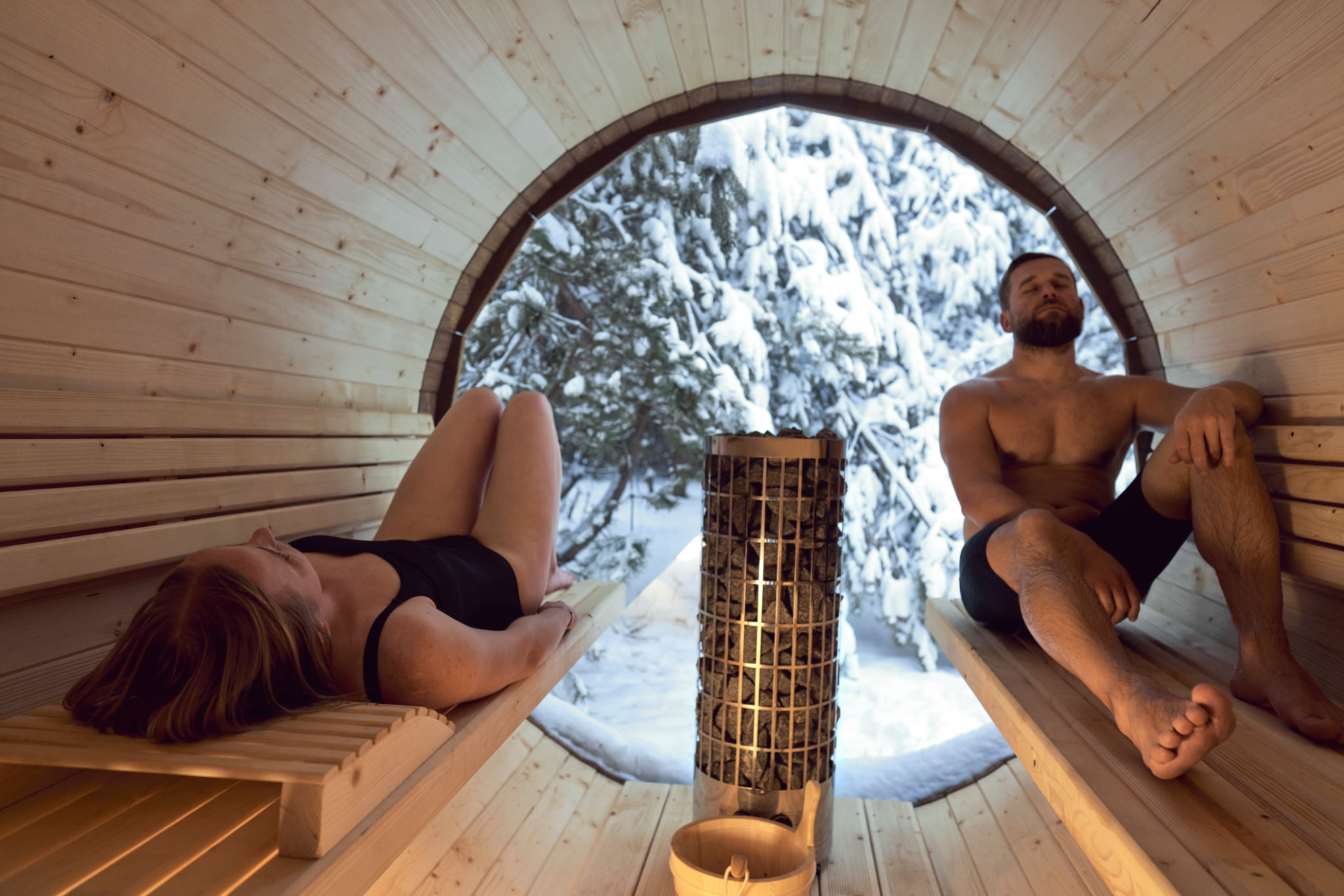 Caucasian adult couple enjoying in the sauna in winter Caucasian adult couple enjoying in the sauna in winter