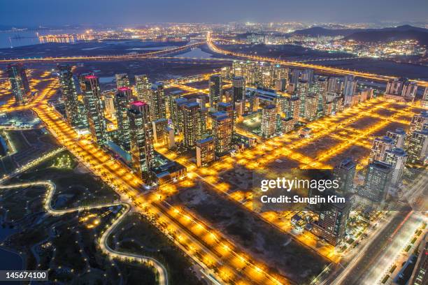 nightscape viewed from rooftop of skyscraper - songdo ibd stock pictures, royalty-free photos & images