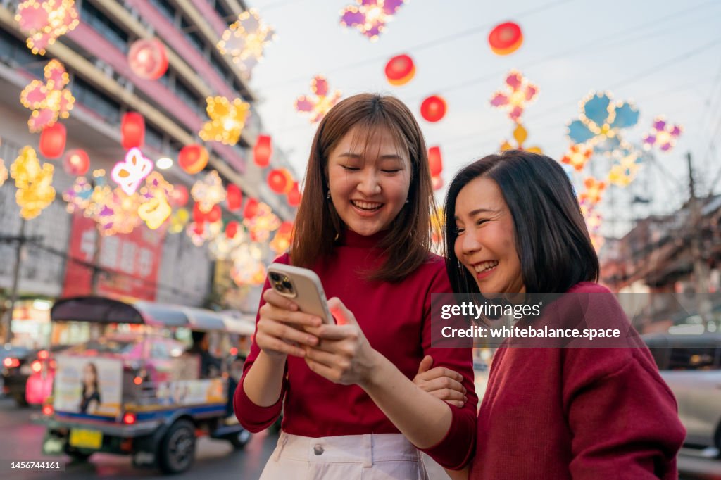 Chinese tourist using smartphone sharing memories for travel.