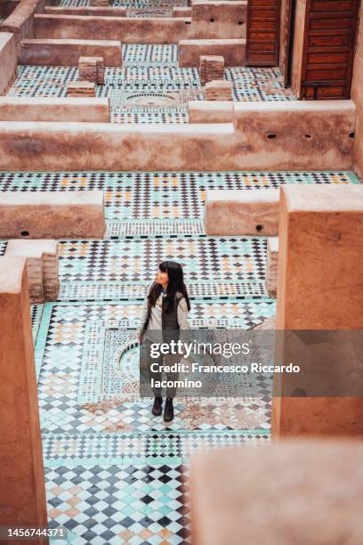 woman and mosaic floor tiles in old  palace, marrakesh - morocco stock pictures, royalty-free photos & images