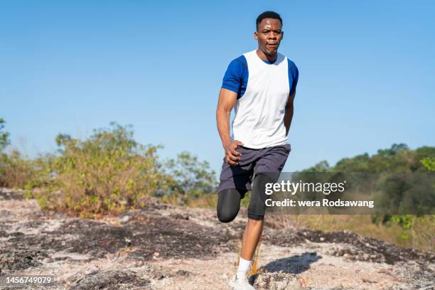 speed running action of black man trail runner - beginner triathlon stock pictures, royalty-free photos & images