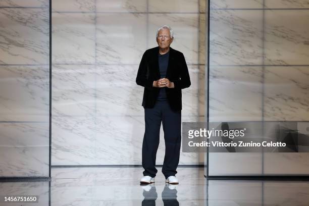 Designer Giorgio Armani acknowledges the applause of the audience on the runway at the Giorgio Armani fashion show during the Milan Menswear...