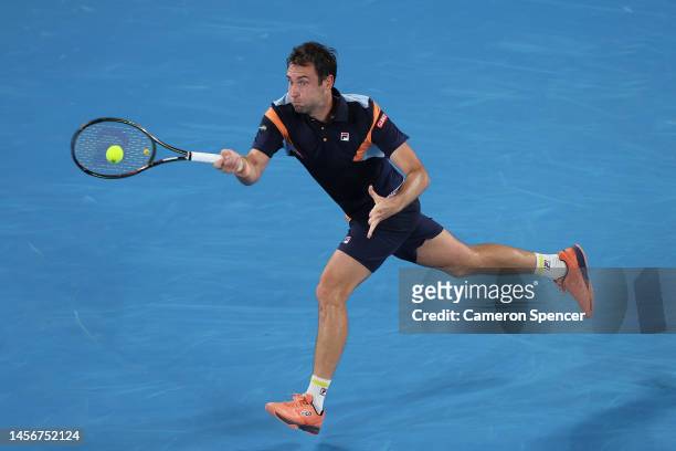 Quentin Halys of France plays a forehand in their round one singles match against Stefanos Tsitsipas of Greece during day one of the 2023 Australian...
