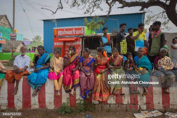 People watch the annual bull-taming sport of Jallikattu played to celebrate the harvest festival of Pongal on January 16, 2023 in Palamedu, near...