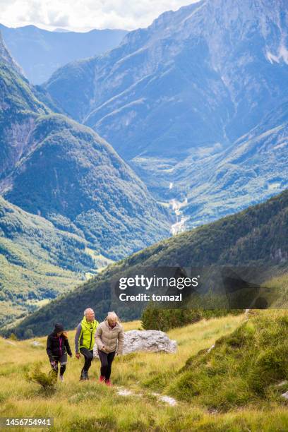 group of young people hiking on the mountain range - people climbing walking mountain group stock pictures, royalty-free photos & images