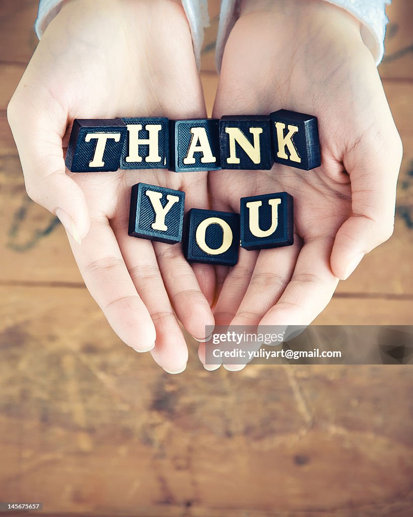 Thank you written in hands