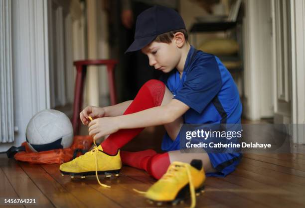 a 7 year old boy, dressed as a footballer, preparing for sports - sports jersey home stock pictures, royalty-free photos & images