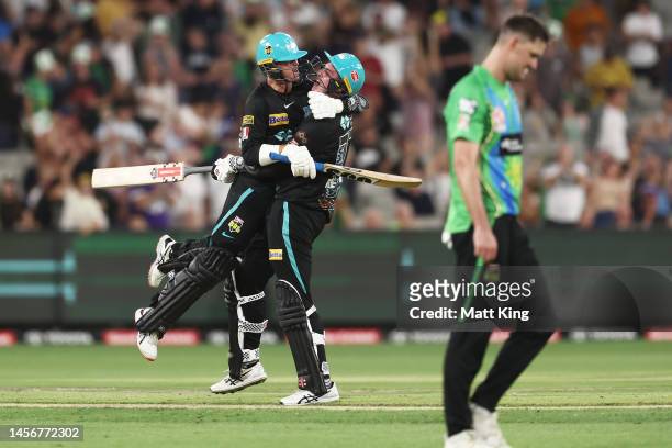 Matthew Renshaw of the Heat celebrates with Matt Kuhnemann after hitting the winning runs on the last ball of the match during the Men's Big Bash...