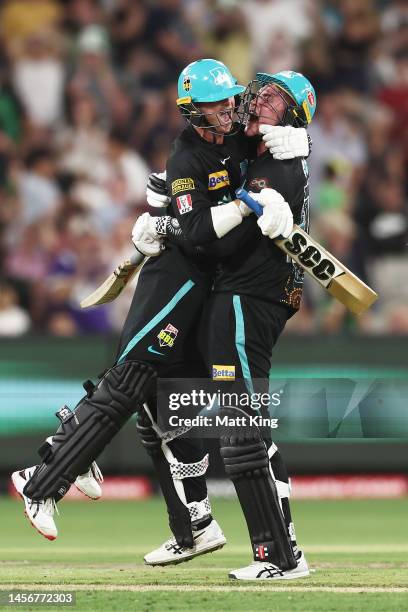 Matthew Renshaw of the Heat celebrates with Matt Kuhnemann after hitting the winning runs on the last ball of the match during the Men's Big Bash...