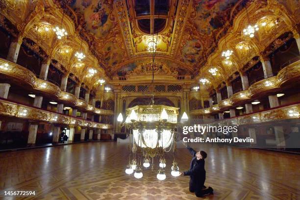 Workman cleans a one tonne Edwardian chandelier lowered into the ballroom at Blackpool Tower ahead of its week long annual clean on January 16, 2023...