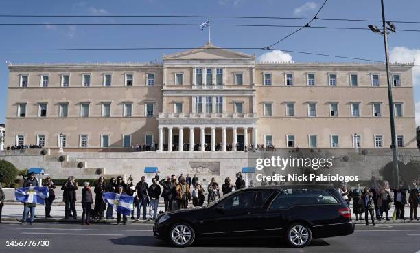 Members of the public line the street as the hearse carrying the coffin of Former King Constantine II of Greece passes by the Hellenic Parliament at...