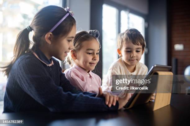 children playing video game using digital tablet at home - parental control stock pictures, royalty-free photos & images