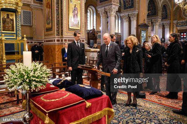 Former King Juan Carlos of Spain and Former Queen Sofia of Spain pay their respects during the funeral of Former King Constantine II of Greece on...