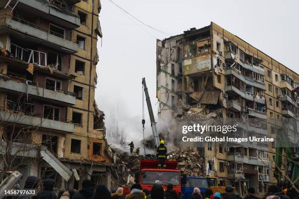 Rescuers use special equipment in searching people trapped under the rubble of a high-rise residential building hit by a missile on January 15, 2023...