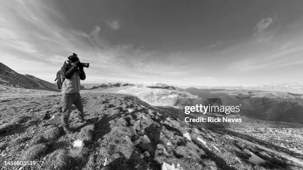 photographer on mountain top of romanian alps - alps romania stock pictures, royalty-free photos & images