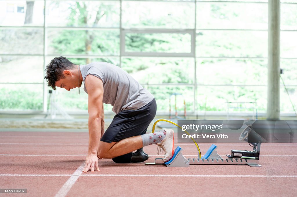 Young Fitness Man With Disabilities Running With Sprinter Starting ...